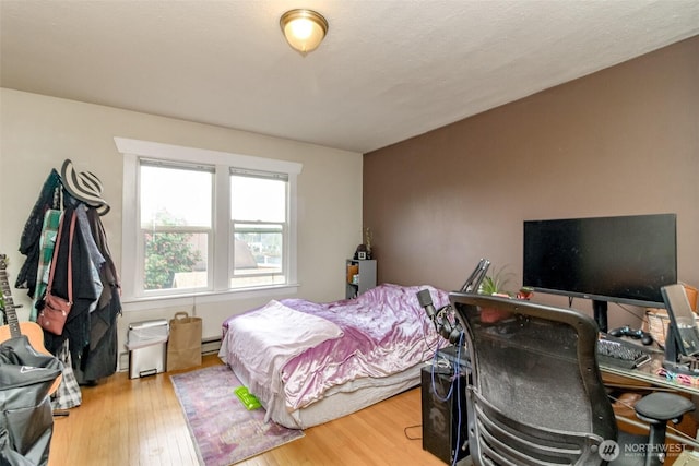 2029 S 7th St, Tacoma, WA 98405 - bedroom with a baseboard heating unit and wood finished floors