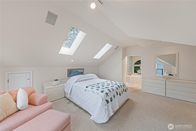 bedroom with lofted ceiling with skylight, visible vents, and carpet floors