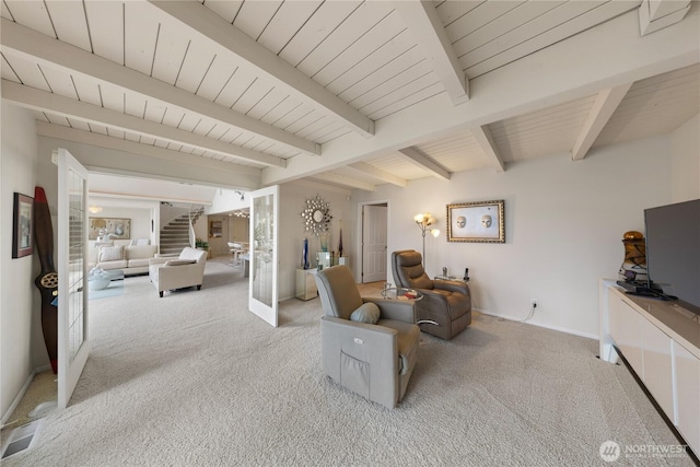 interior space with beam ceiling, stairway, visible vents, and baseboards