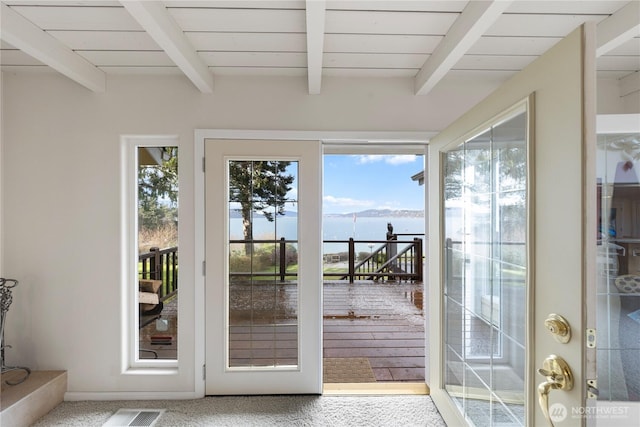 doorway with beam ceiling and wooden ceiling