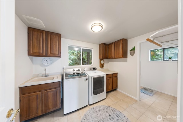 laundry room featuring cabinet space, independent washer and dryer, a wealth of natural light, and a sink