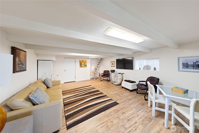 living area with beamed ceiling and wood finished floors