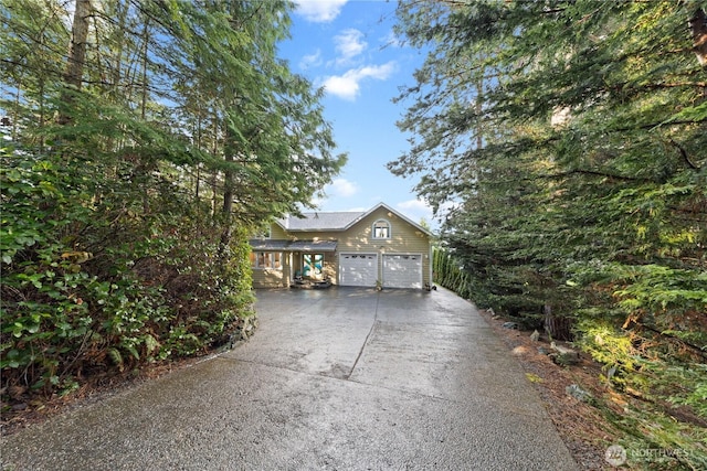 garage featuring concrete driveway