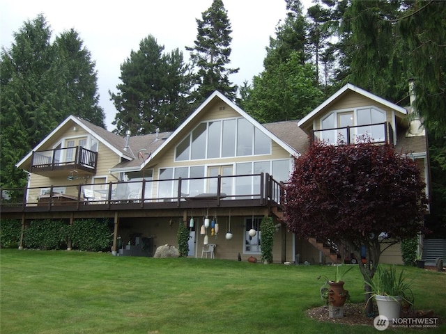 back of house with a lawn, a wooden deck, stairs, and roof with shingles