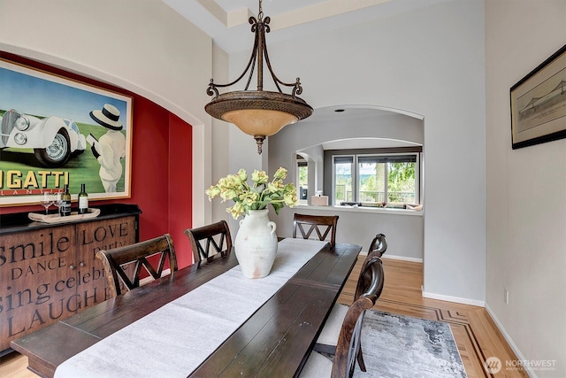 dining area featuring baseboards and wood finished floors