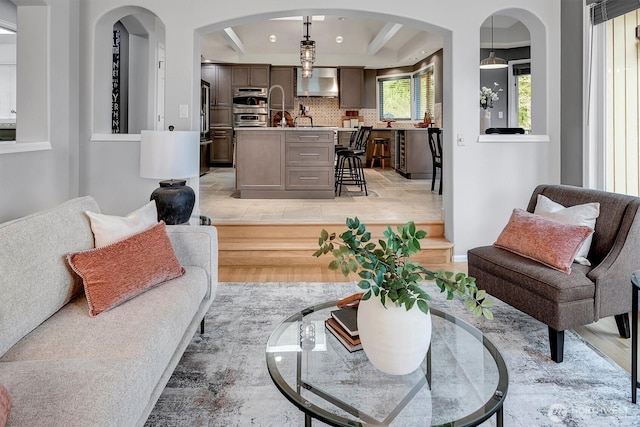 living area featuring a tray ceiling and recessed lighting