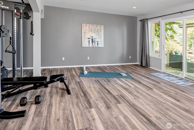 workout room with recessed lighting, wood finished floors, and baseboards