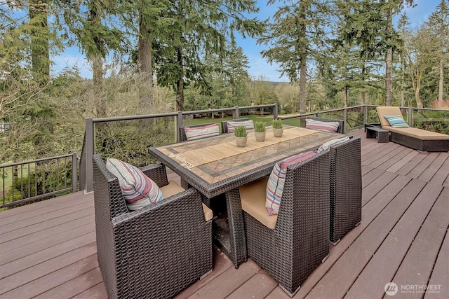 wooden terrace featuring outdoor dining space