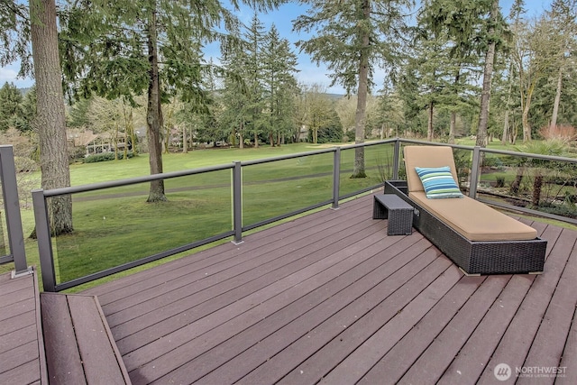 wooden terrace featuring a yard