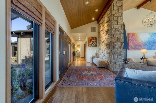 hall featuring visible vents, wood ceiling, and wood finished floors