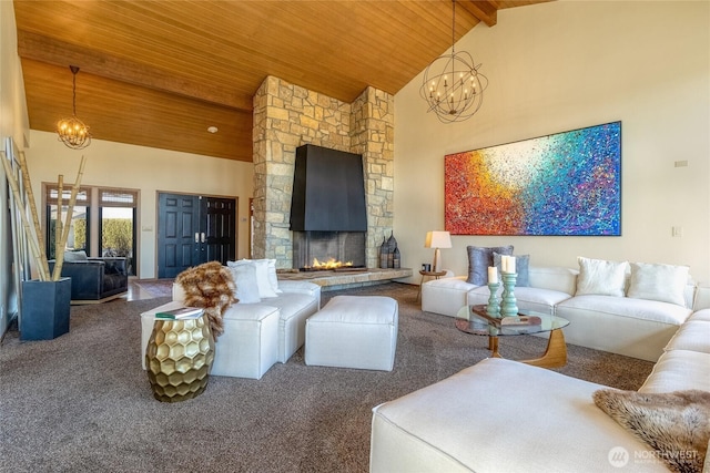 carpeted living room with wooden ceiling, a notable chandelier, and high vaulted ceiling