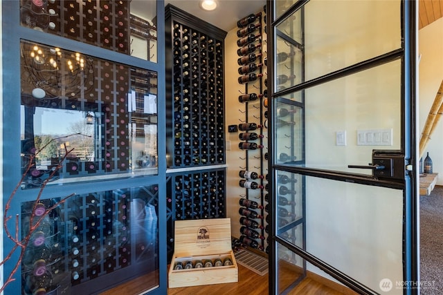 wine cellar with a chandelier and wood finished floors