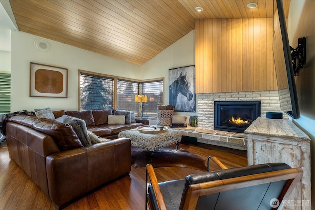 living area with wood ceiling, a brick fireplace, wood finished floors, and high vaulted ceiling