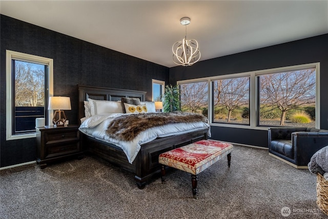 carpeted bedroom featuring baseboards and an inviting chandelier