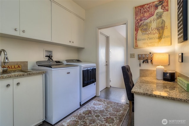 laundry area with washer and clothes dryer, cabinet space, and a sink