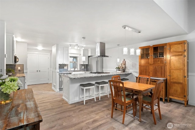 dining area featuring light wood finished floors