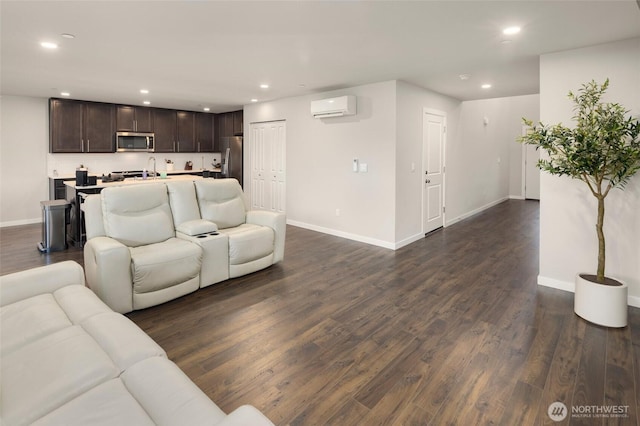 living area with recessed lighting, baseboards, dark wood finished floors, and a wall mounted AC