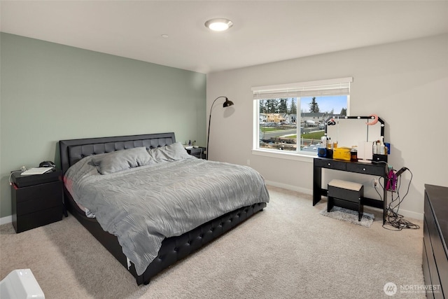 carpeted bedroom with baseboards