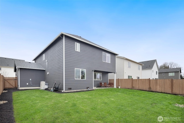 back of property with a patio area, a yard, and a fenced backyard