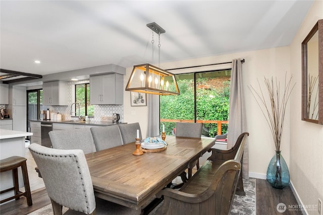 dining space with baseboards and dark wood-style floors