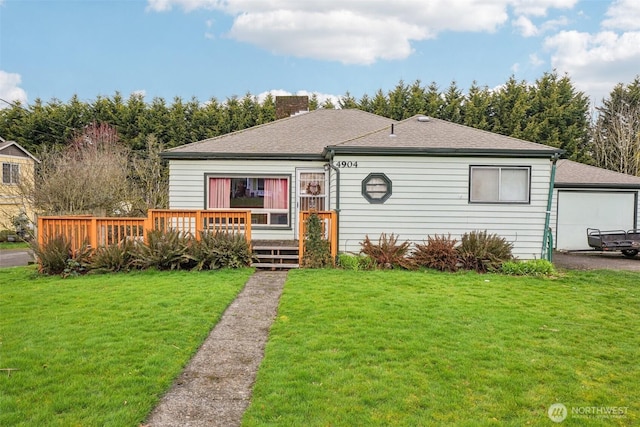 view of front of property featuring a wooden deck, a front lawn, roof with shingles, and a chimney