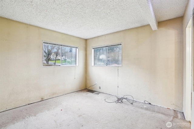 spare room featuring a textured ceiling