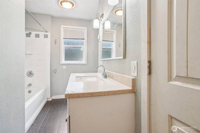 bathroom with vanity, shower / bath combination, baseboards, and wood tiled floor