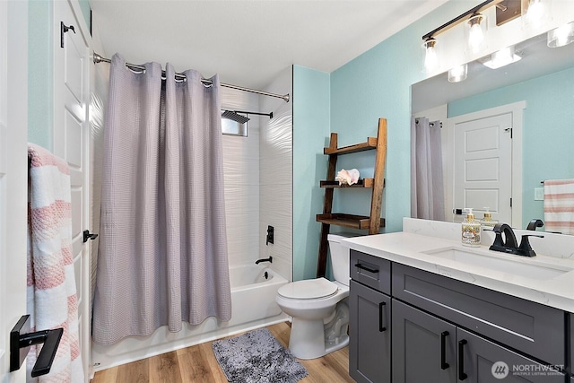 bathroom featuring vanity, toilet, wood finished floors, and shower / tub combo with curtain