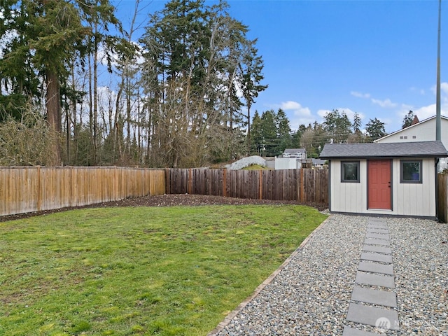 view of yard featuring an outbuilding and a fenced backyard