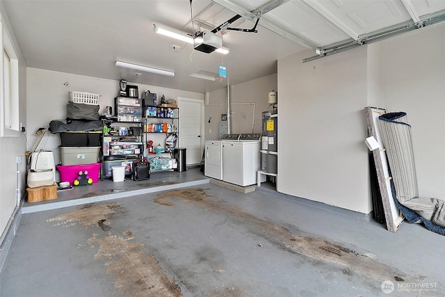 garage with a garage door opener, washing machine and dryer, and water heater