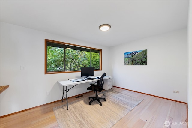 office with visible vents, baseboards, and light wood-style floors