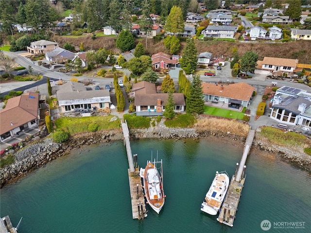 birds eye view of property featuring a residential view and a water view