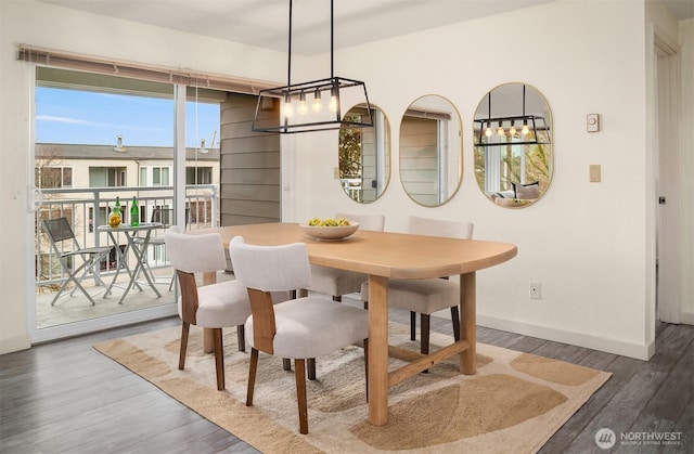 dining area featuring baseboards and wood finished floors