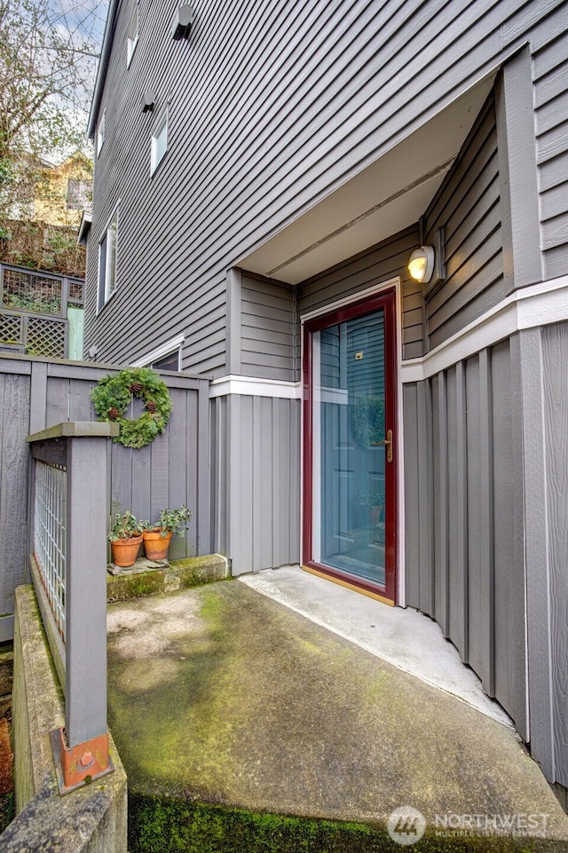 doorway to property featuring fence