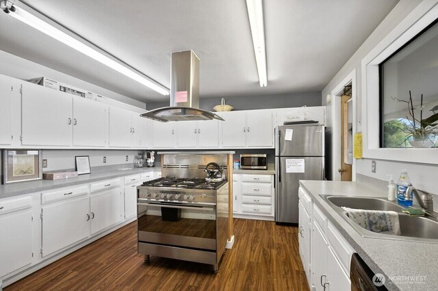 1402 22nd St NE Unit 402, Auburn, WA 98002 - kitchen featuring a sink, dark wood-type flooring, island range hood, white cabinetry, and appliances with stainless steel finishes