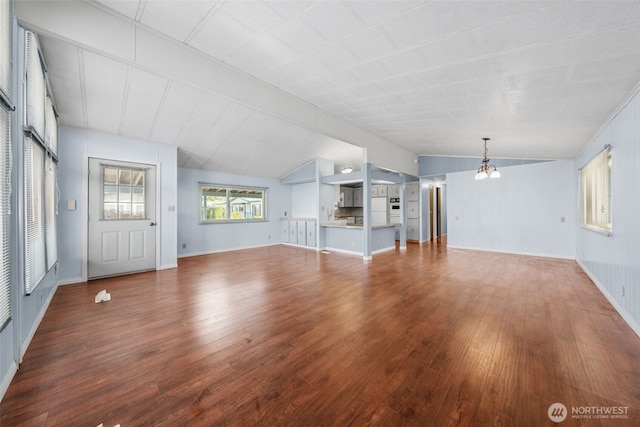 1402 22nd St NE Unit 402, Auburn, WA 98002 - unfurnished living room featuring lofted ceiling, a notable chandelier, and wood finished floors