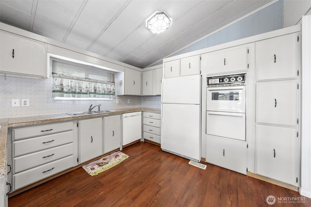 1402 22nd St NE Unit 402, Auburn, WA 98002 - kitchen with dark wood-style flooring, white appliances, light countertops, decorative backsplash, and lofted ceiling