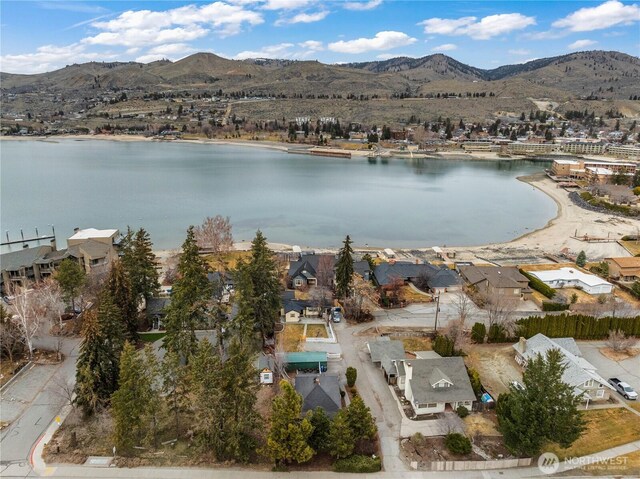 drone / aerial view featuring a residential view and a water and mountain view