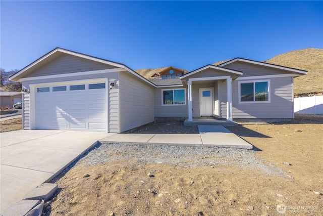 ranch-style home with concrete driveway and an attached garage