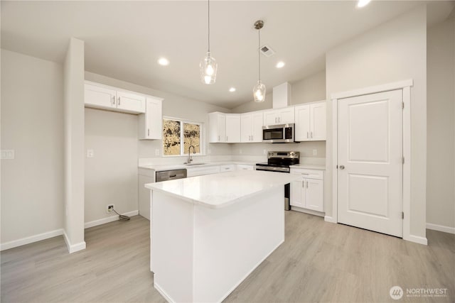 kitchen with visible vents, white cabinets, stainless steel appliances, and a sink