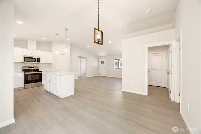 kitchen with stainless steel appliances, light wood-style floors, and white cabinetry