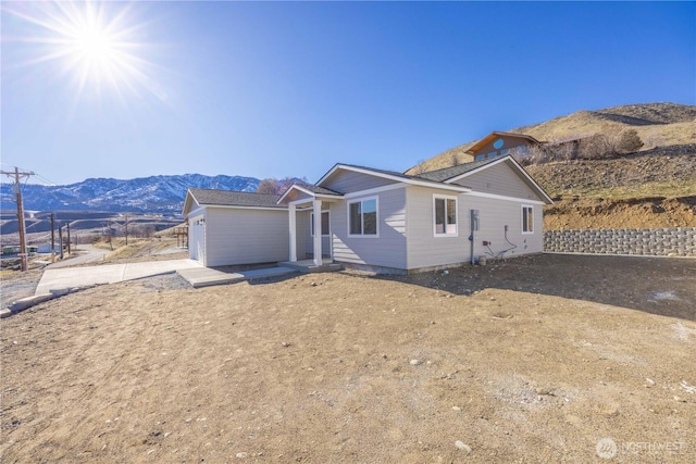 view of front of home featuring a mountain view and fence