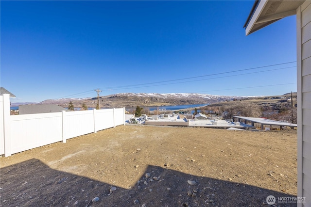 view of yard with a mountain view and fence