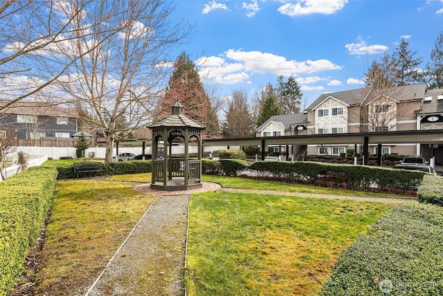 view of home's community with a gazebo, a yard, fence, and a residential view