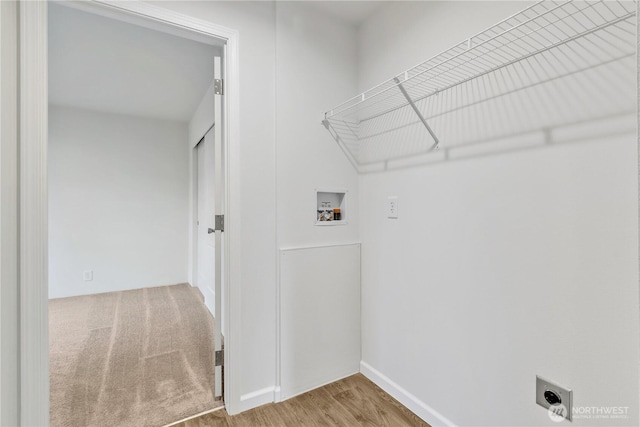 clothes washing area featuring washer hookup, laundry area, wood finished floors, and electric dryer hookup