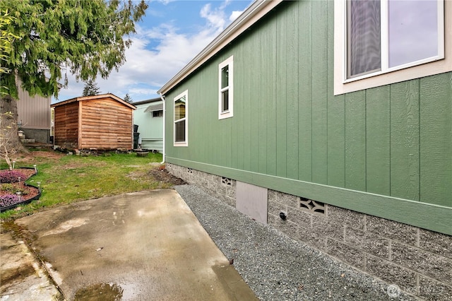 view of side of home featuring crawl space, a storage unit, an outdoor structure, and a patio