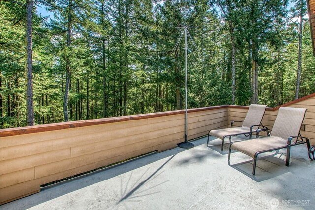 view of patio featuring a wooded view