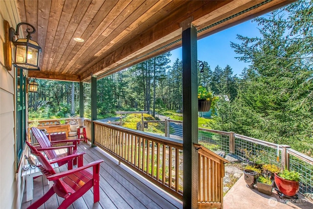 wooden terrace with view of scattered trees