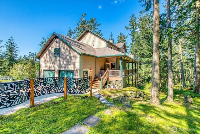 view of front of house featuring stairway, a porch, an attached garage, a chimney, and a front lawn