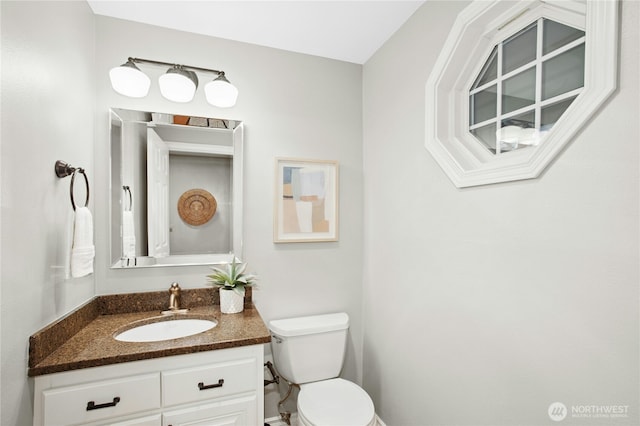 bathroom featuring toilet and vanity